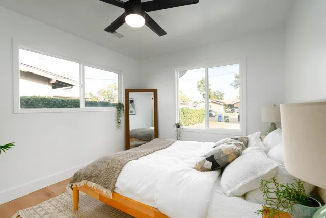 a bedroom with a bed and wooden floor