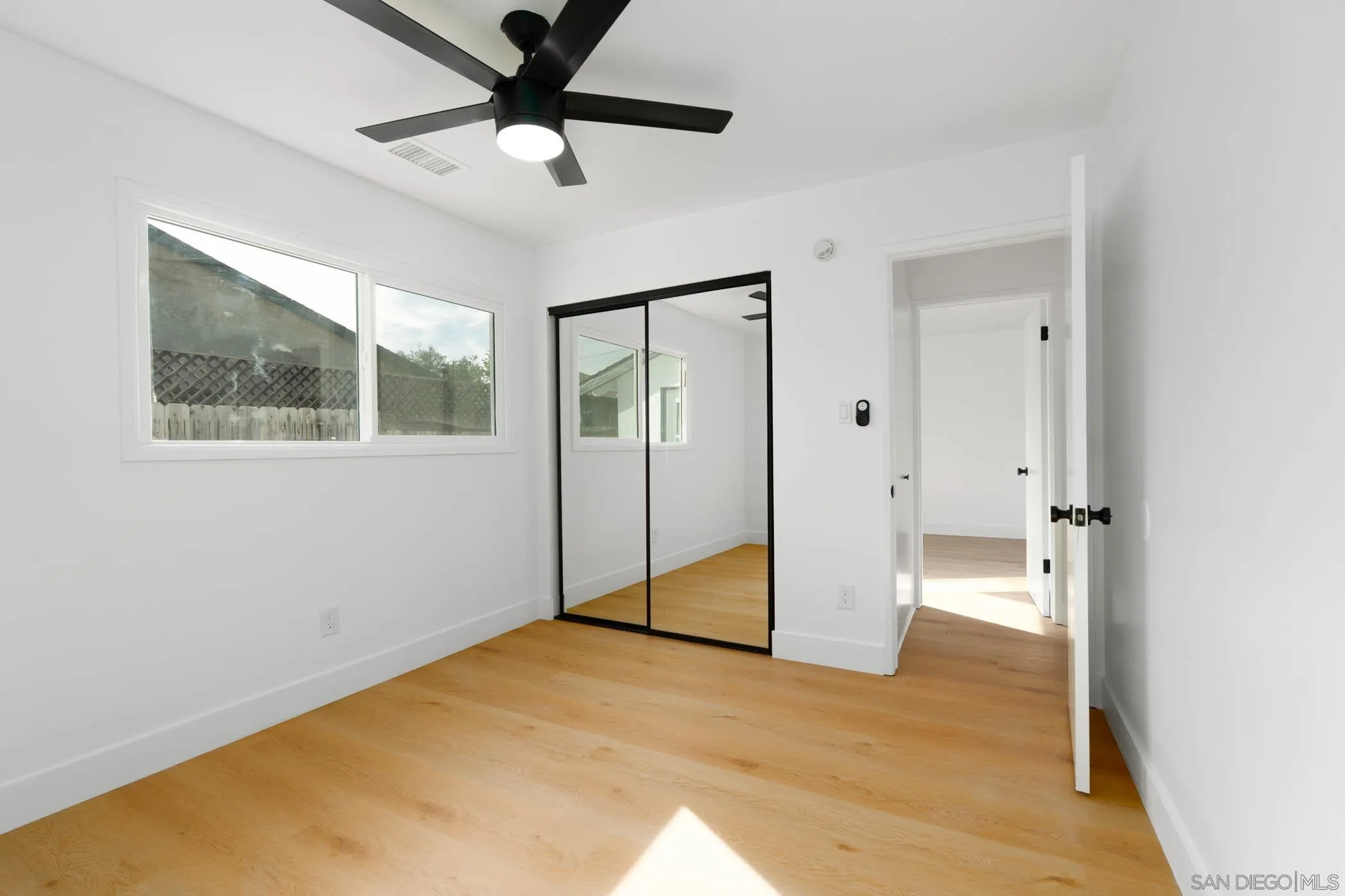 12918 Seiler Street Poway, CA 92064 - Photo 18 of 25 a view of empty room with wooden floor and ceiling fan