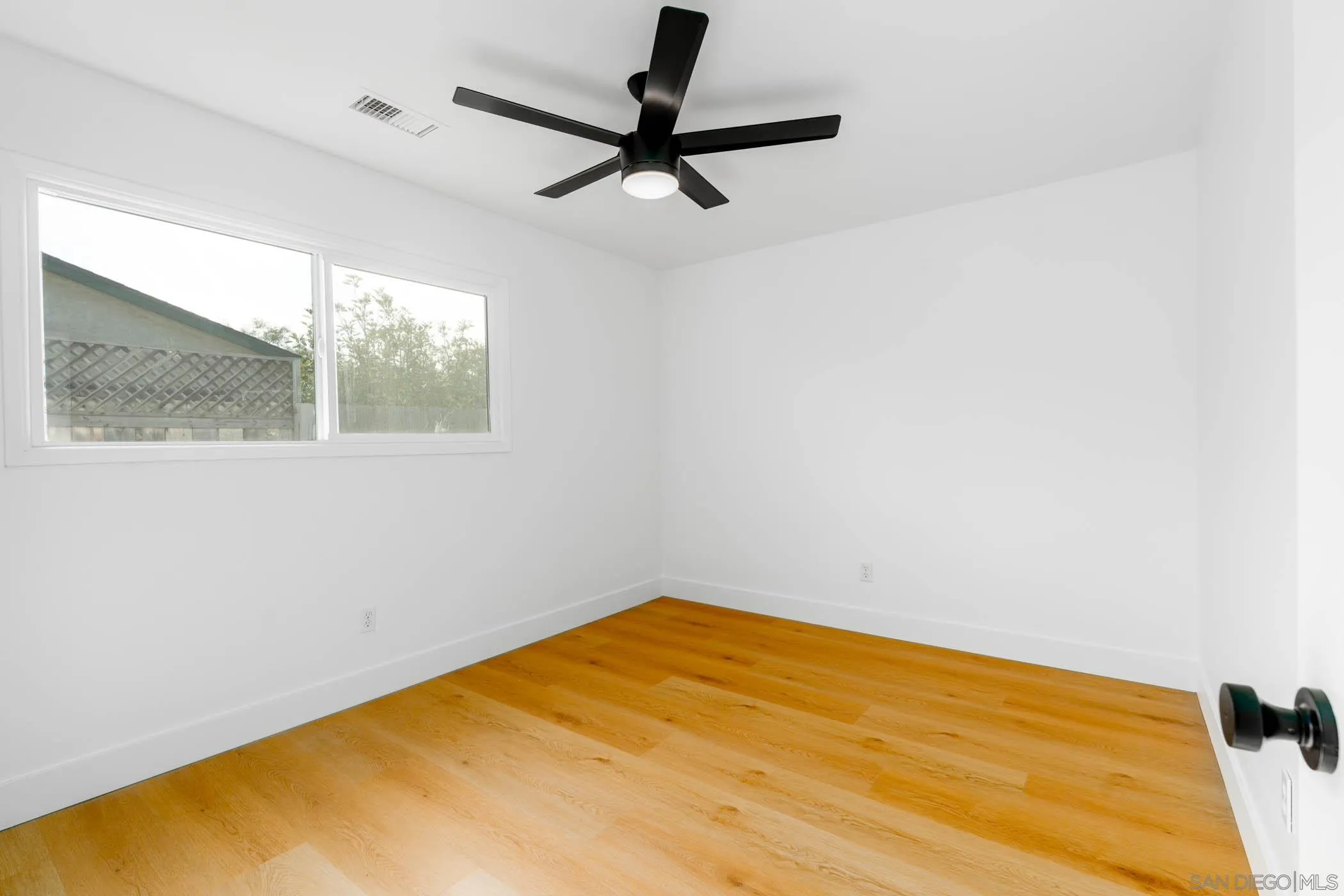 12918 Seiler Street Poway, CA 92064 - Photo 19 of 25 a view of a big room with wooden floor and windows