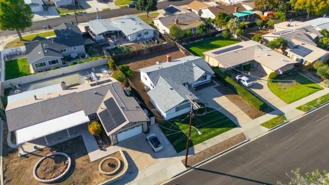an aerial view of residential house with outdoor space and parking