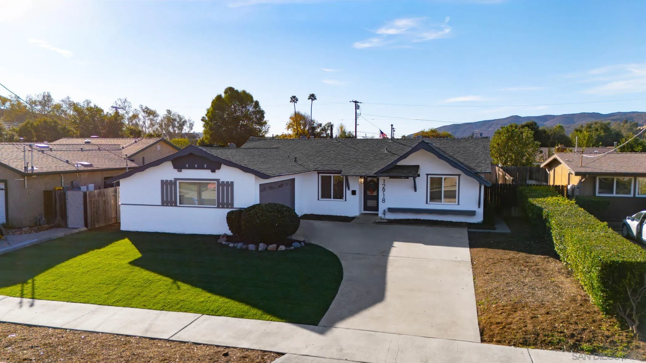 12918 Seiler Street Poway, CA 92064 - Photo 3 of 25 a front view of a house with a yard and garage
