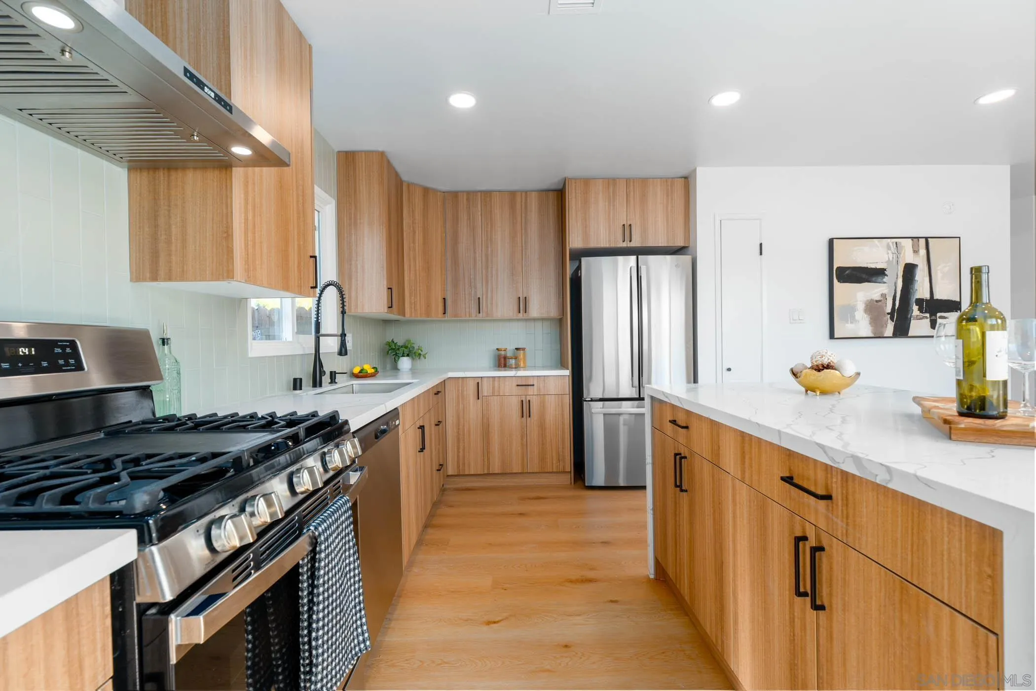12918 Seiler Street Poway, CA 92064 - Photo 9 of 25 a kitchen with stainless steel appliances a sink stove and refrigerator