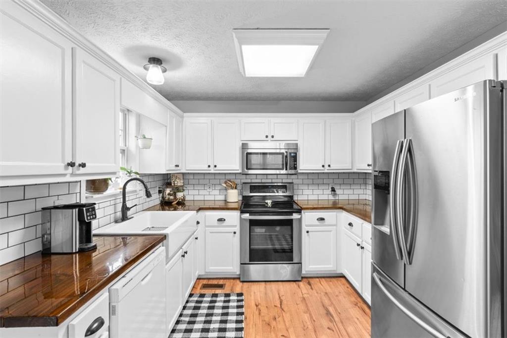 93 4th Street Emerson, GA 30137 - Photo 14 of 46 a kitchen with stainless steel appliances a refrigerator sink and cabinets
