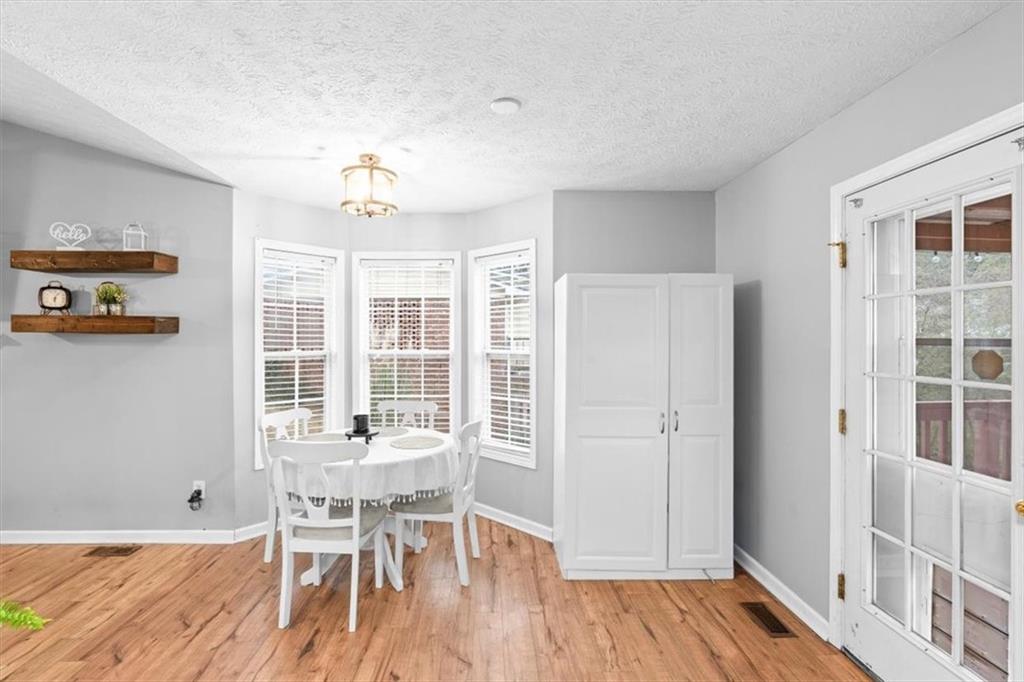 93 4th Street Emerson, GA 30137 - Photo 18 of 46 a dining room with wooden floor and breakfast area