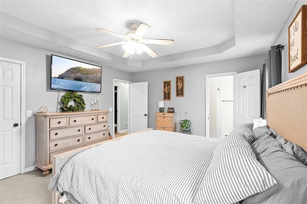 93 4th Street Emerson, GA 30137 - Photo 20 of 46 a bedroom with a large bed and a mirror on dresser