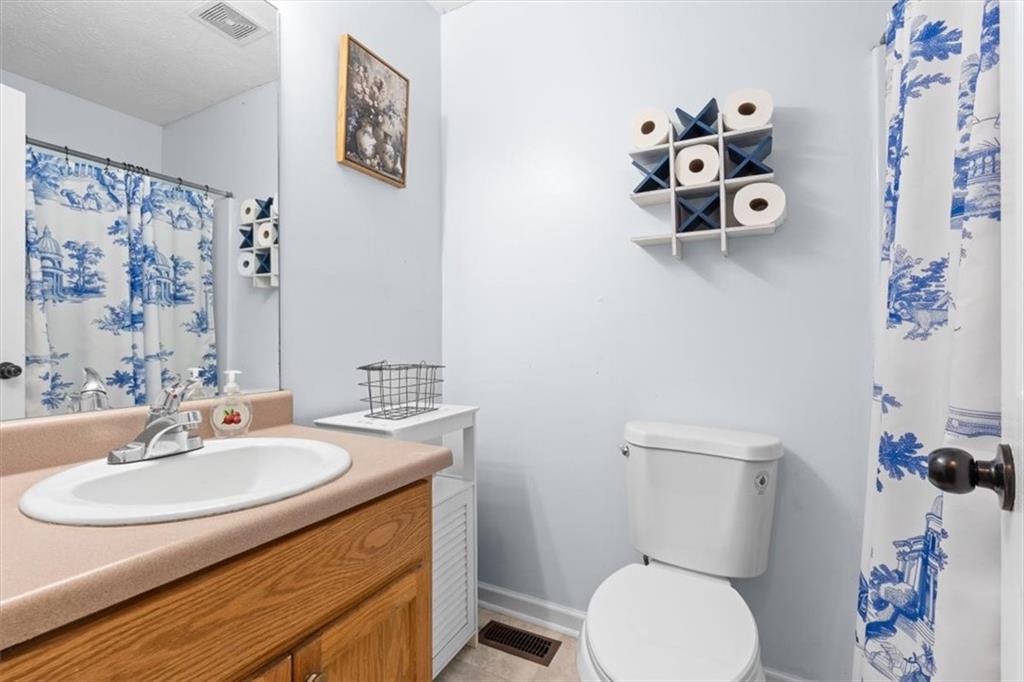 93 4th Street Emerson, GA 30137 - Photo 21 of 46 a bathroom with a sink mirror and toilet