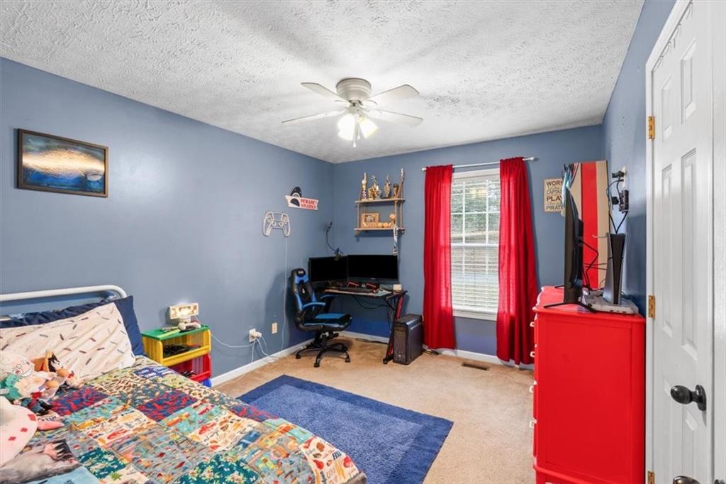 93 4th Street Emerson, GA 30137 - Photo 22 of 46 a bed room with a bed and a tv