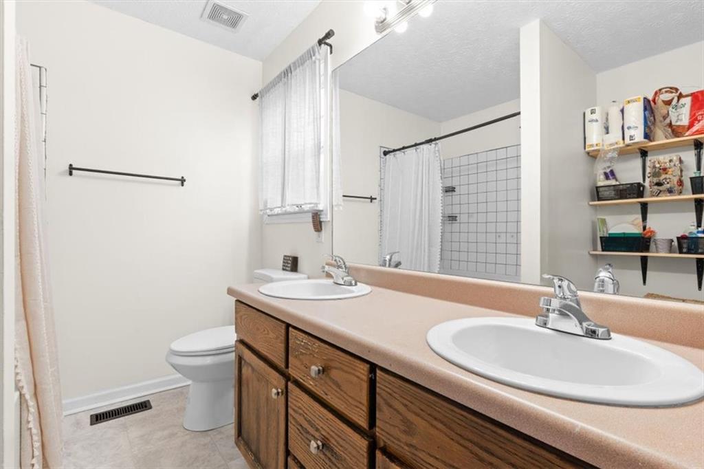 93 4th Street Emerson, GA 30137 - Photo 23 of 46 a bathroom with a granite countertop sink a toilet and a large mirror