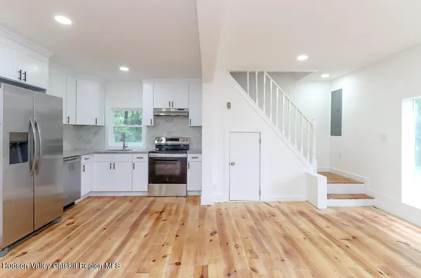 a kitchen with stainless steel appliances a refrigerator and a stove top oven