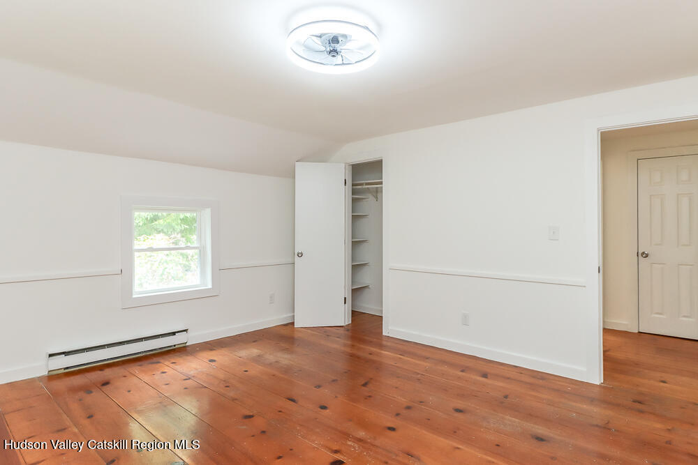 68 Orinsekwa Road Valatie, NY 12184 - Photo 19 of 41 an empty room with wooden floor and windows