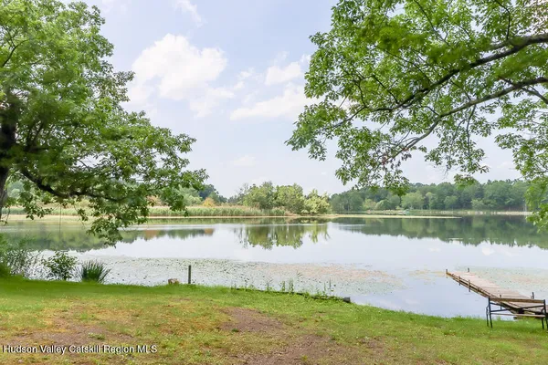 a view of a lake with houses in the back