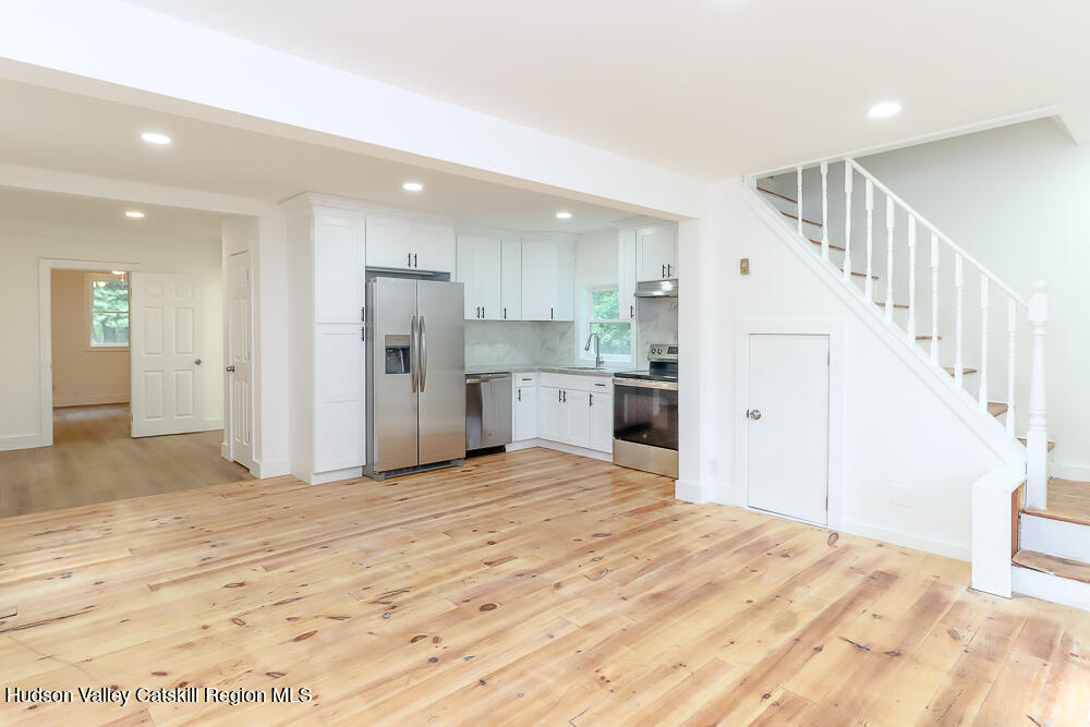 68 Orinsekwa Road Valatie, NY 12184 - Photo 3 of 41 a view of a kitchen with refrigerator and white cabinets