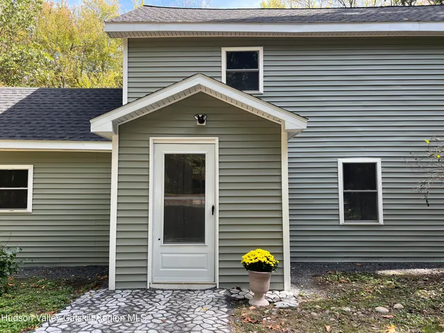 a view of a small space with wooden floor and a window