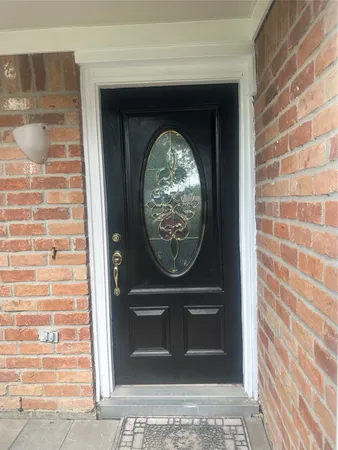 a view of an empty room with window chandelier