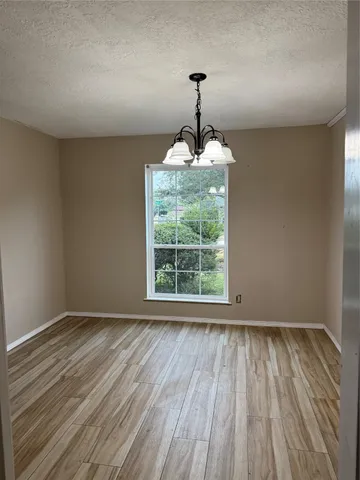 a view of an empty room with a fireplace and a window