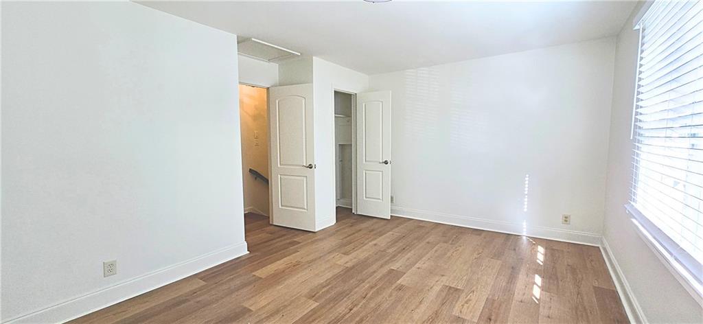 2826 Whippoorwill Circle Northwest Duluth, GA 30097 - Photo 14 of 24 an empty room with wooden floor and windows