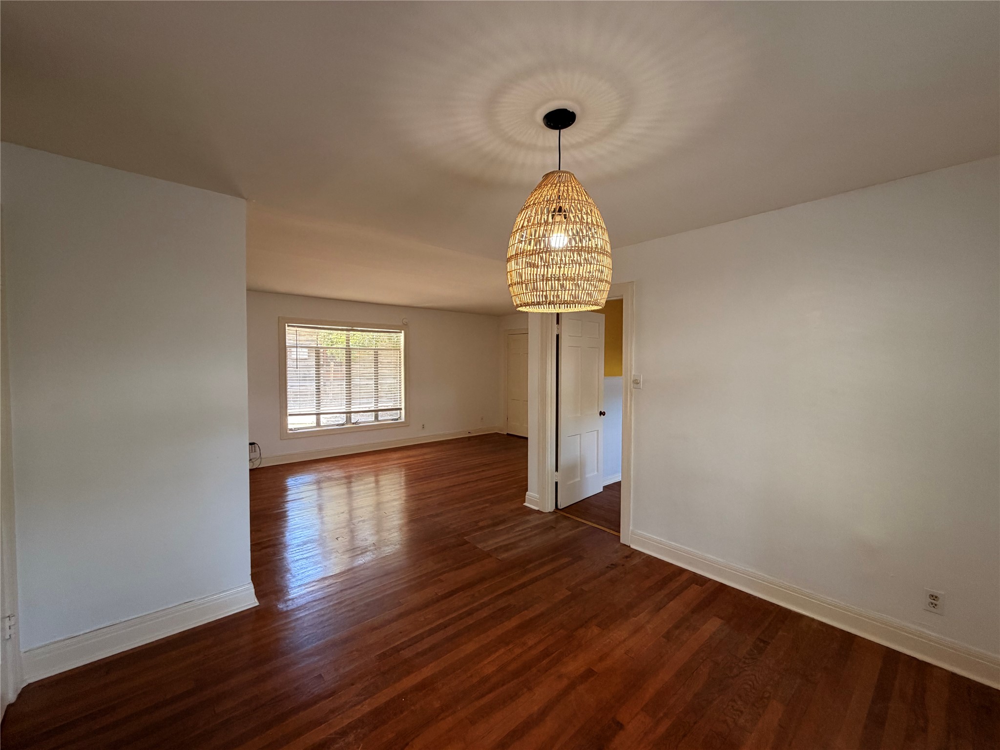 2511 Enfield Road, Unit A Austin, TX 78703 - Photo 2 of 7 Hardwood floors stretch across this inviting living space, illuminated by natural light.