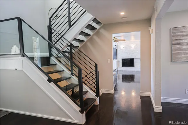 a view of entryway and hall with wooden floor