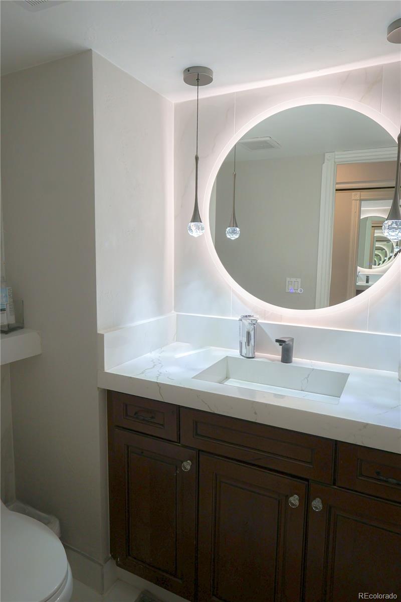 5661 West Lakeridge Road Denver, CO 80227 - Photo 16 of 48 a bathroom with a sink and mirror