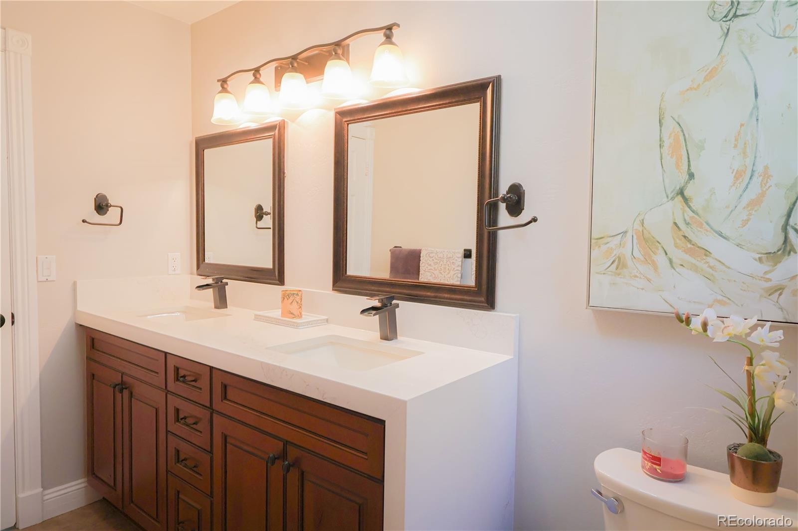 5661 West Lakeridge Road Denver, CO 80227 - Photo 20 of 48 a bathroom with a sink and a mirror