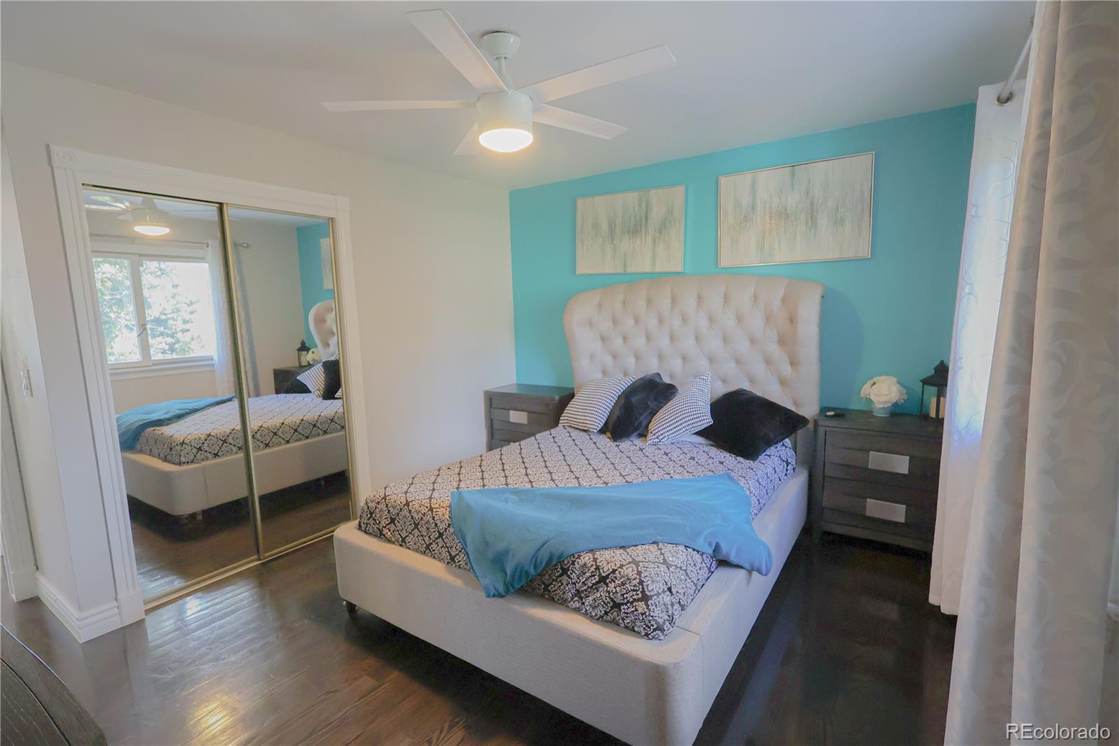 5661 West Lakeridge Road Denver, CO 80227 - Photo 22 of 48 a bedroom with a bed and wooden floor