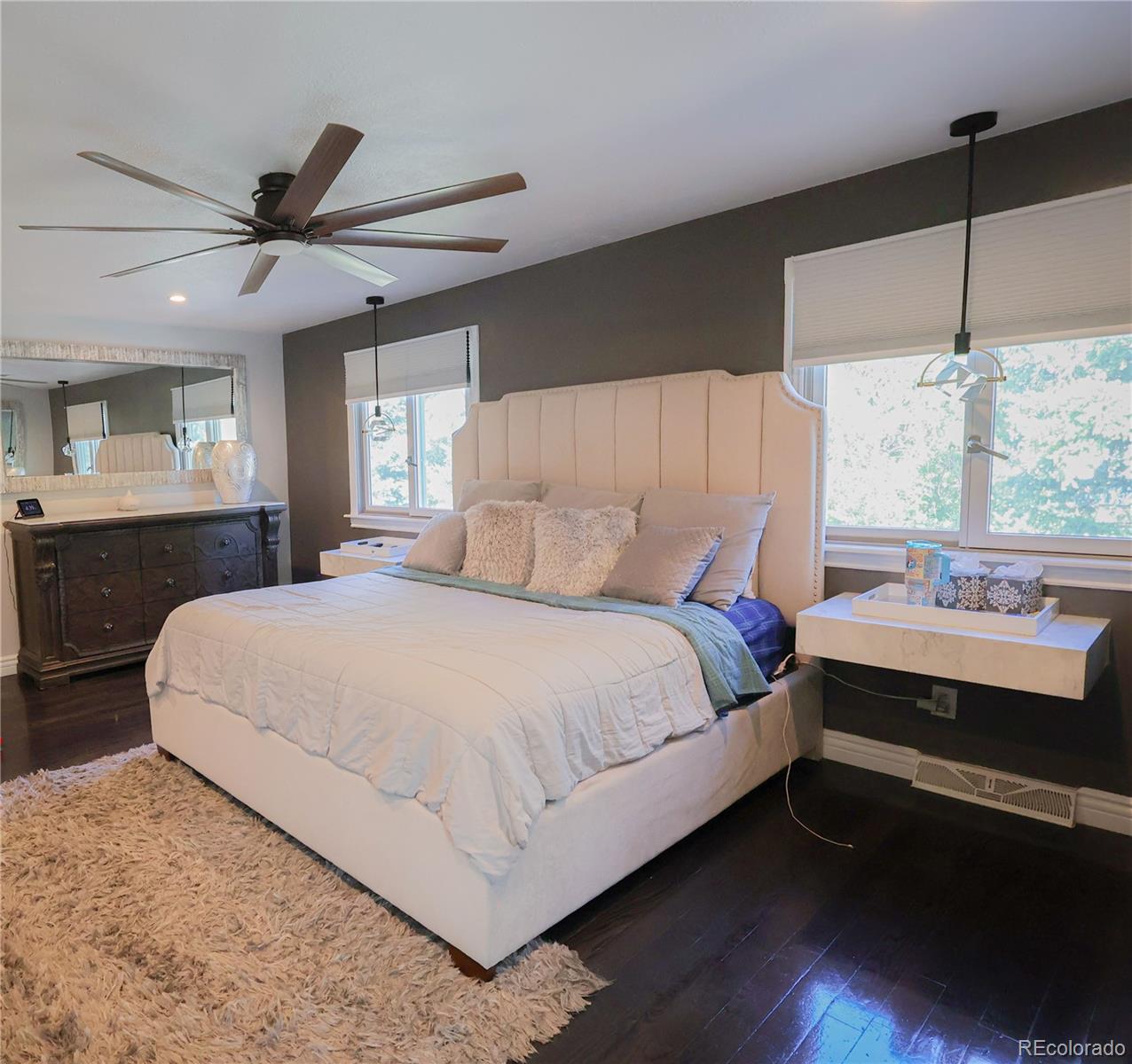 5661 West Lakeridge Road Denver, CO 80227 - Photo 24 of 48 a bedroom with a large bed and a chandelier fan