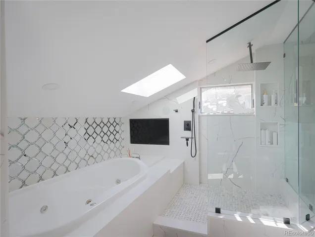 a bathroom with a bathtub and a shower