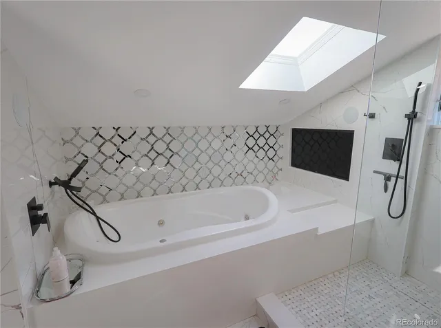 a bathroom with a tub and a shower
