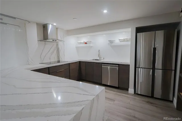 a kitchen with stainless steel appliances a refrigerator and a sink