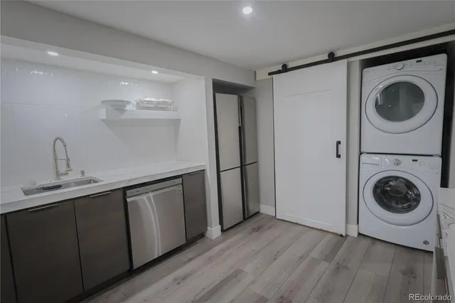 a utility room with sink dryer and washer