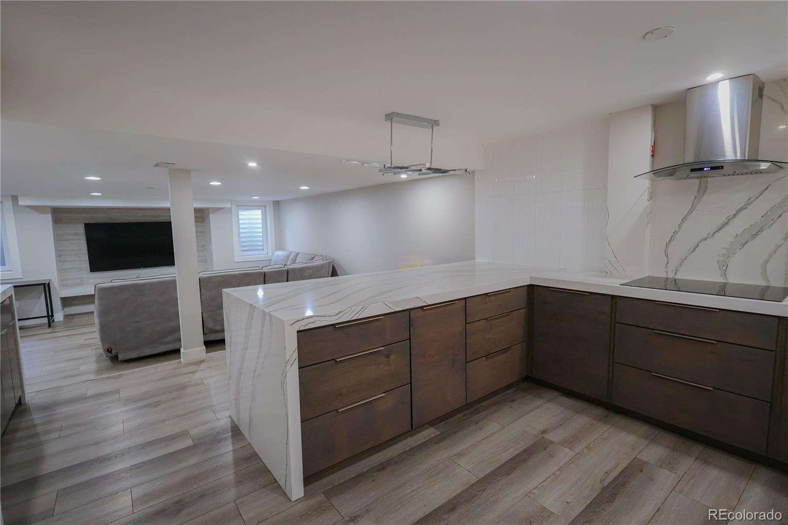 5661 West Lakeridge Road Denver, CO 80227 - Photo 31 of 48 a kitchen with stainless steel appliances kitchen island granite countertop a refrigerator and a stove top oven