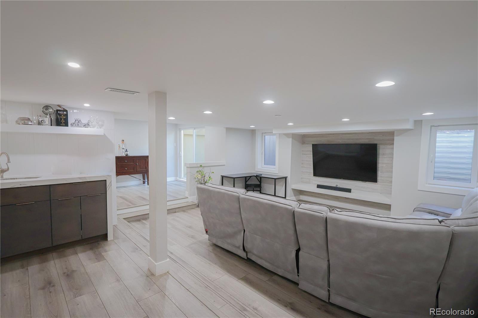 5661 West Lakeridge Road Denver, CO 80227 - Photo 32 of 48 a living room with furniture and a flat screen tv