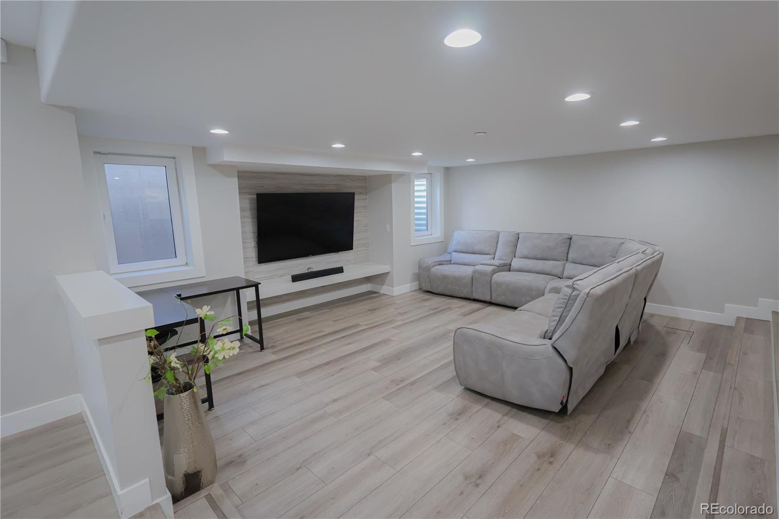 5661 West Lakeridge Road Denver, CO 80227 - Photo 33 of 48 a living room with furniture and a flat screen tv