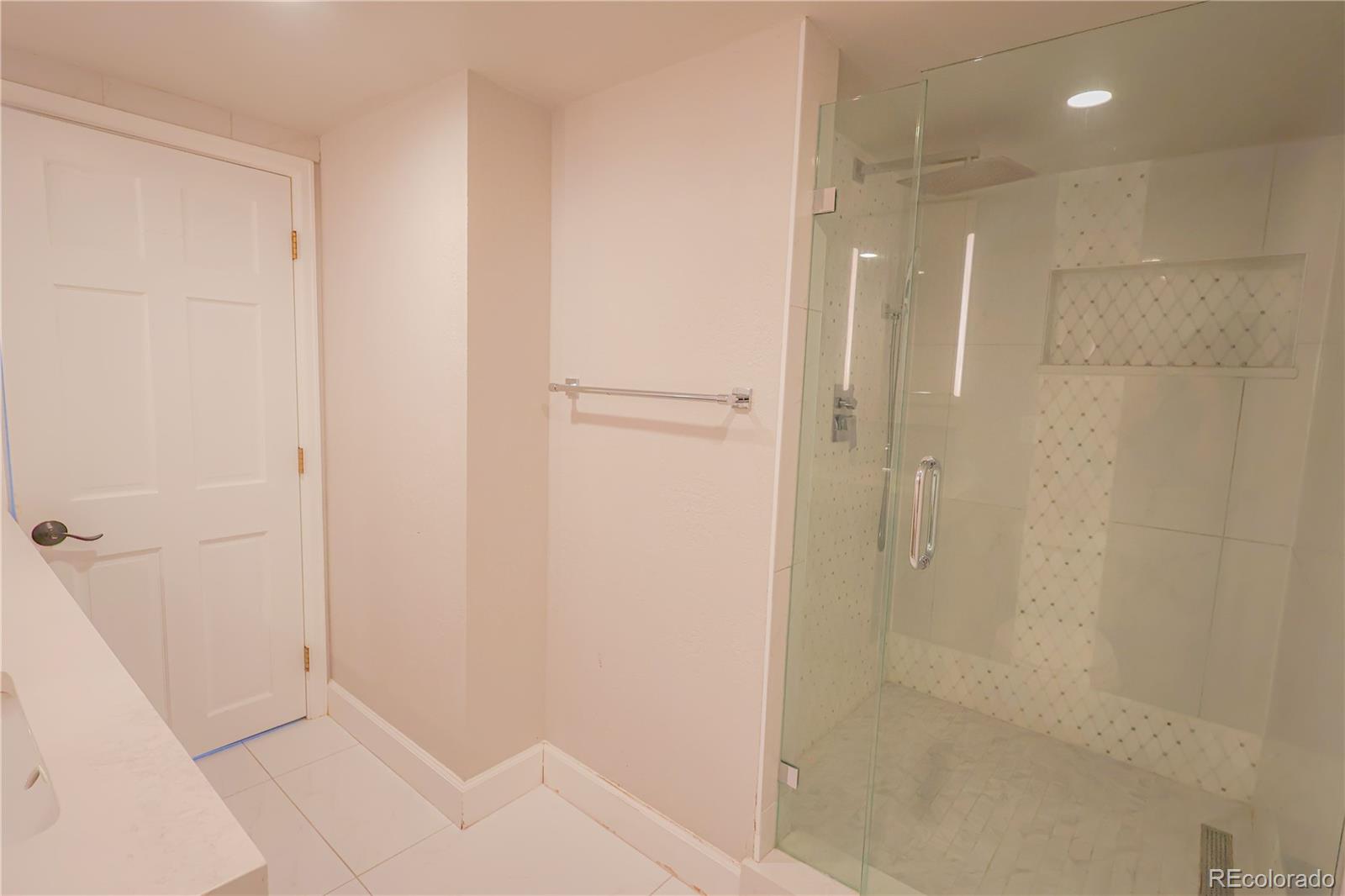 5661 West Lakeridge Road Denver, CO 80227 - Photo 35 of 48 a bathroom with a shower