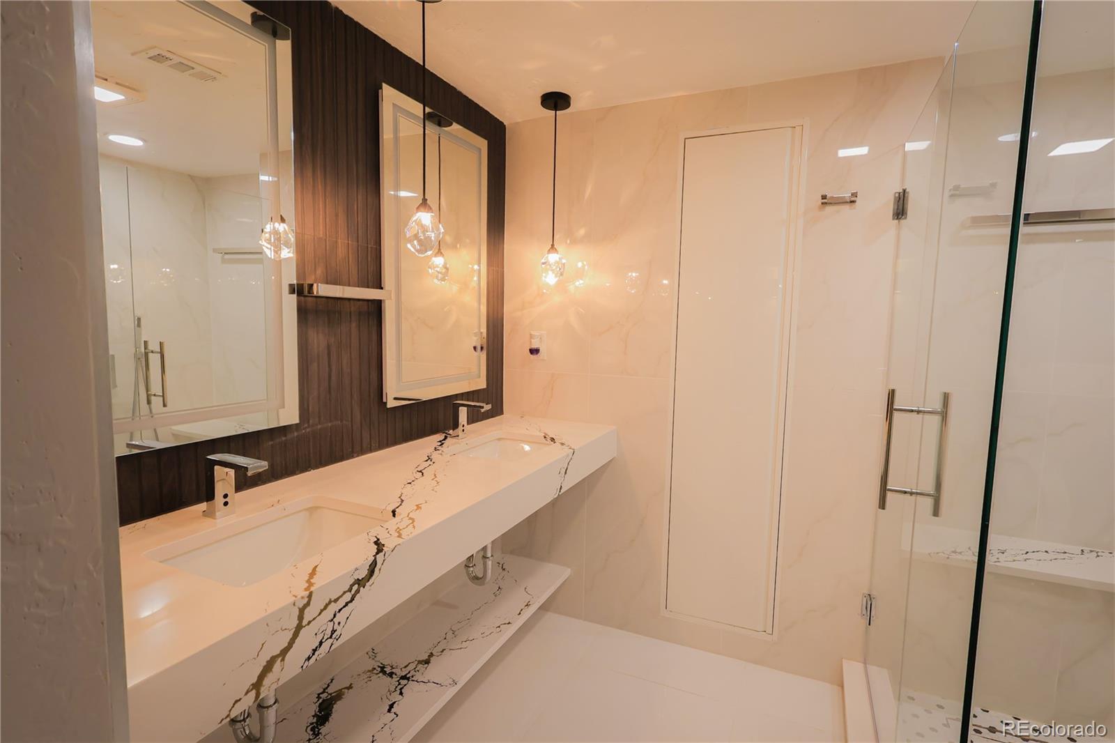 5661 West Lakeridge Road Denver, CO 80227 - Photo 38 of 48 a bathroom with a double vanity sink and a mirror