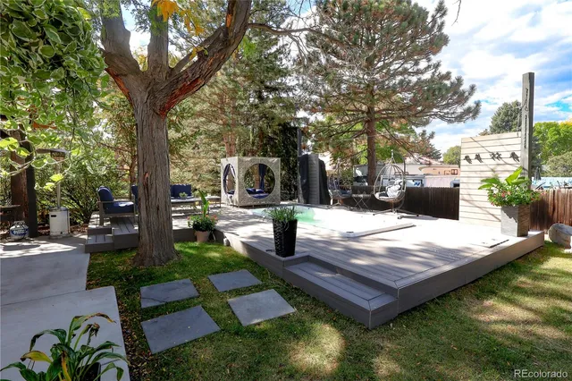 a view of a patio with a table and chairs under an umbrella
