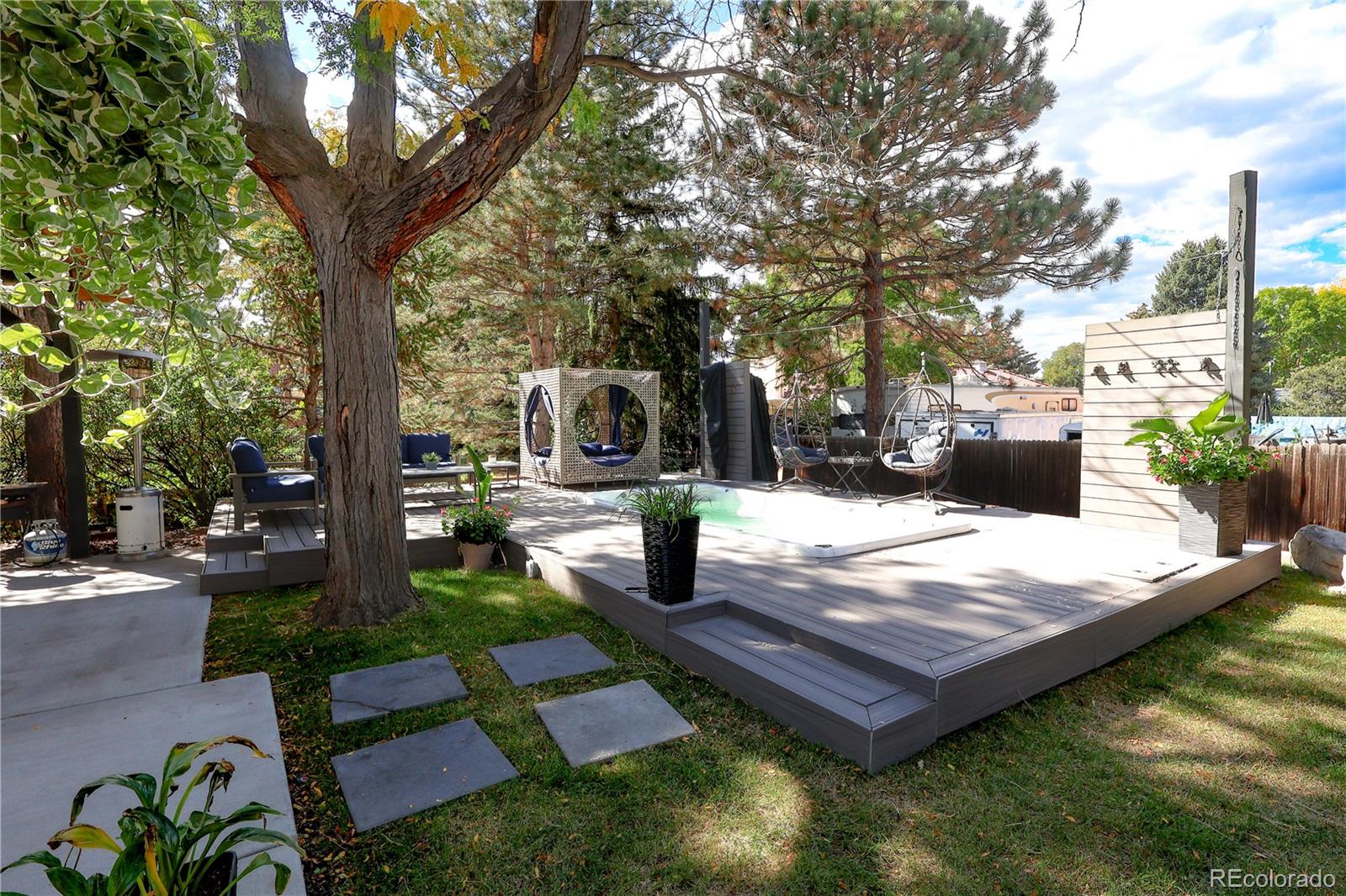 5661 West Lakeridge Road Denver, CO 80227 - Photo 46 of 48 a wooden bench sitting in the middle of a yard