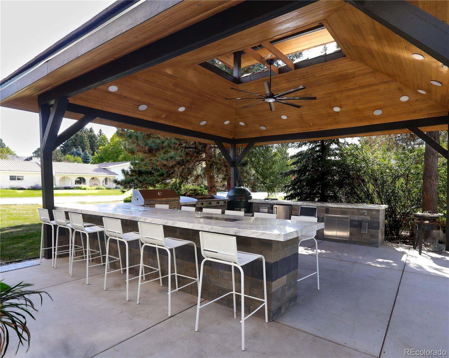 5661 West Lakeridge Road Denver, CO 80227 - Photo 47 of 48 a view of a patio with a table and chairs under an umbrella