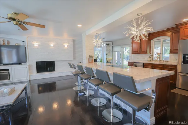 a living room with furniture a flat screen tv and kitchen view
