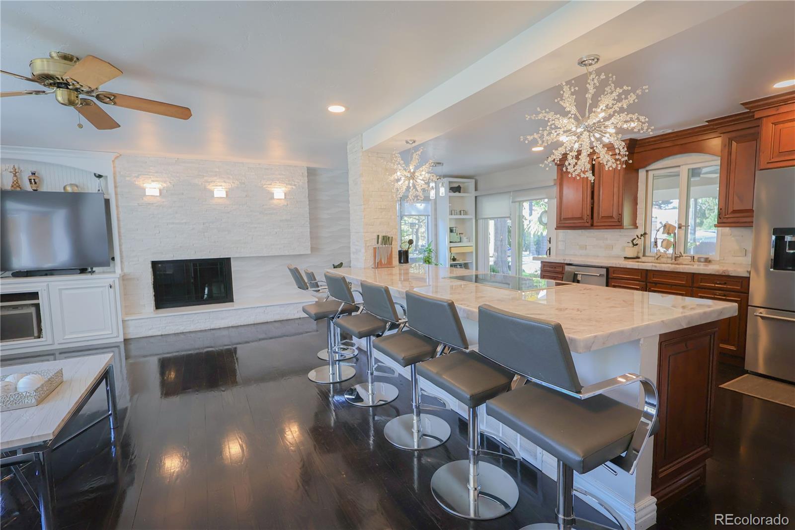 5661 West Lakeridge Road Denver, CO 80227 - Photo 6 of 48 a living room with furniture a flat screen tv and kitchen view