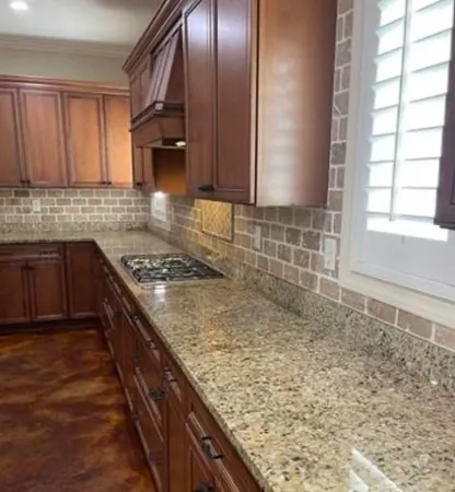 a kitchen with sink cabinets and stove