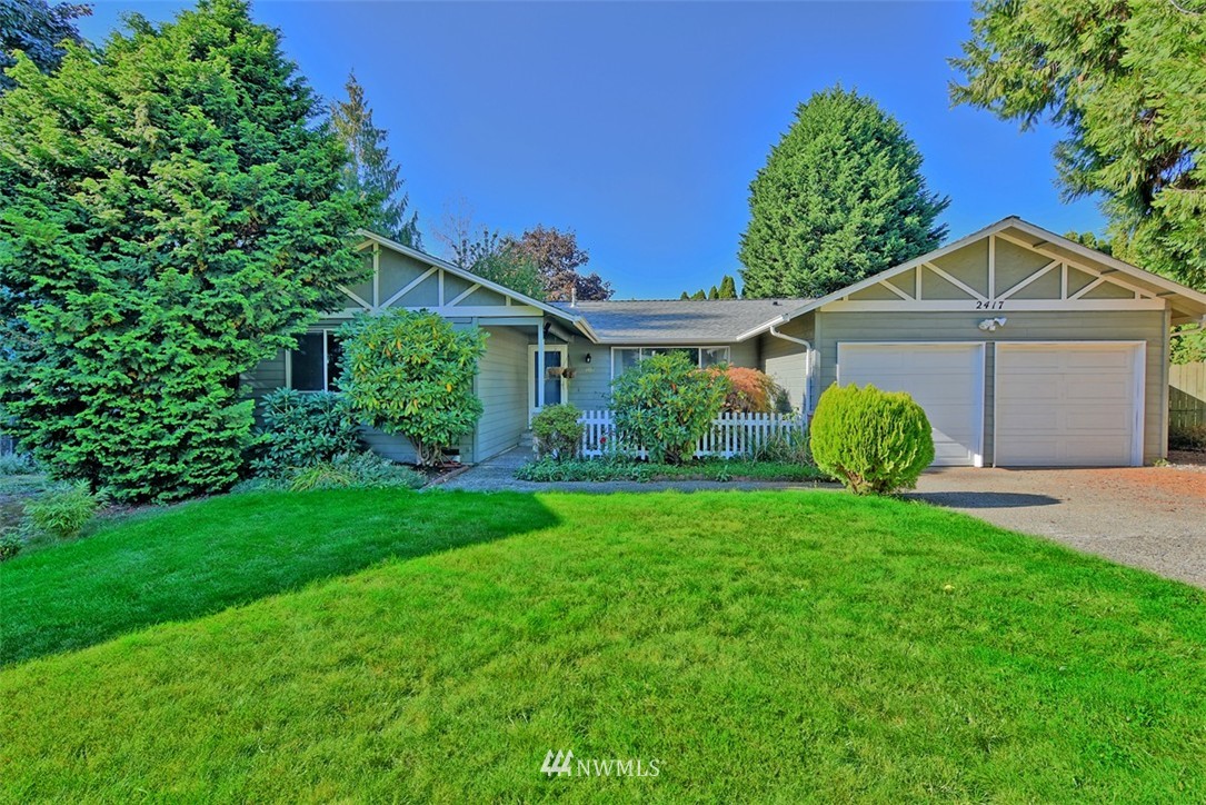 2417 171st Street Southeast Bothell, WA 98012 - Photo 1 of 18 a view of a house with a big yard potted plants and a large tree