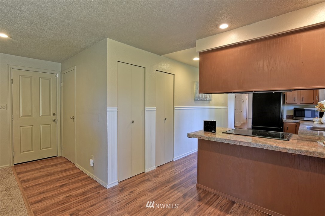 2417 171st Street Southeast Bothell, WA 98012 - Photo 11 of 18 a view of kitchen with kitchen island wooden floor and living room