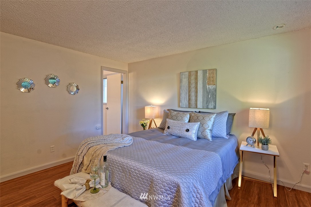 2417 171st Street Southeast Bothell, WA 98012 - Photo 12 of 18 a bedroom with a bed and a lamp