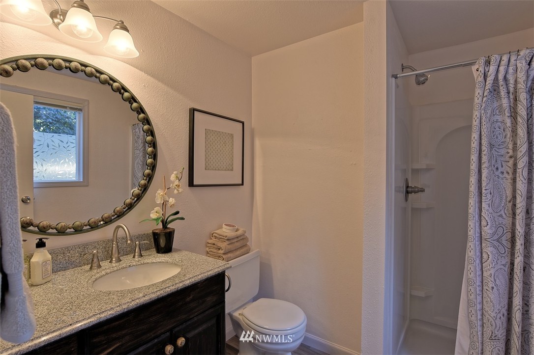 2417 171st Street Southeast Bothell, WA 98012 - Photo 14 of 18 a bathroom with a granite countertop sink mirror vanity and toilet