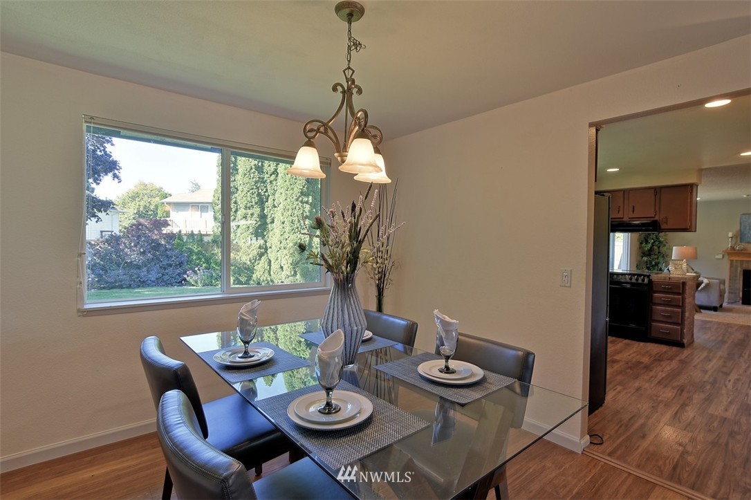 2417 171st Street Southeast Bothell, WA 98012 - Photo 4 of 18 a view of a dining room with furniture window and wooden floor