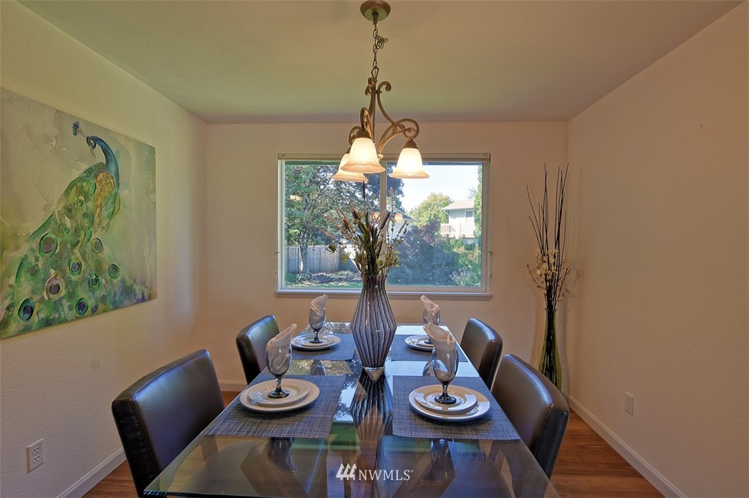 2417 171st Street Southeast Bothell, WA 98012 - Photo 5 of 18 a view of a dining room with furniture window and wooden floor