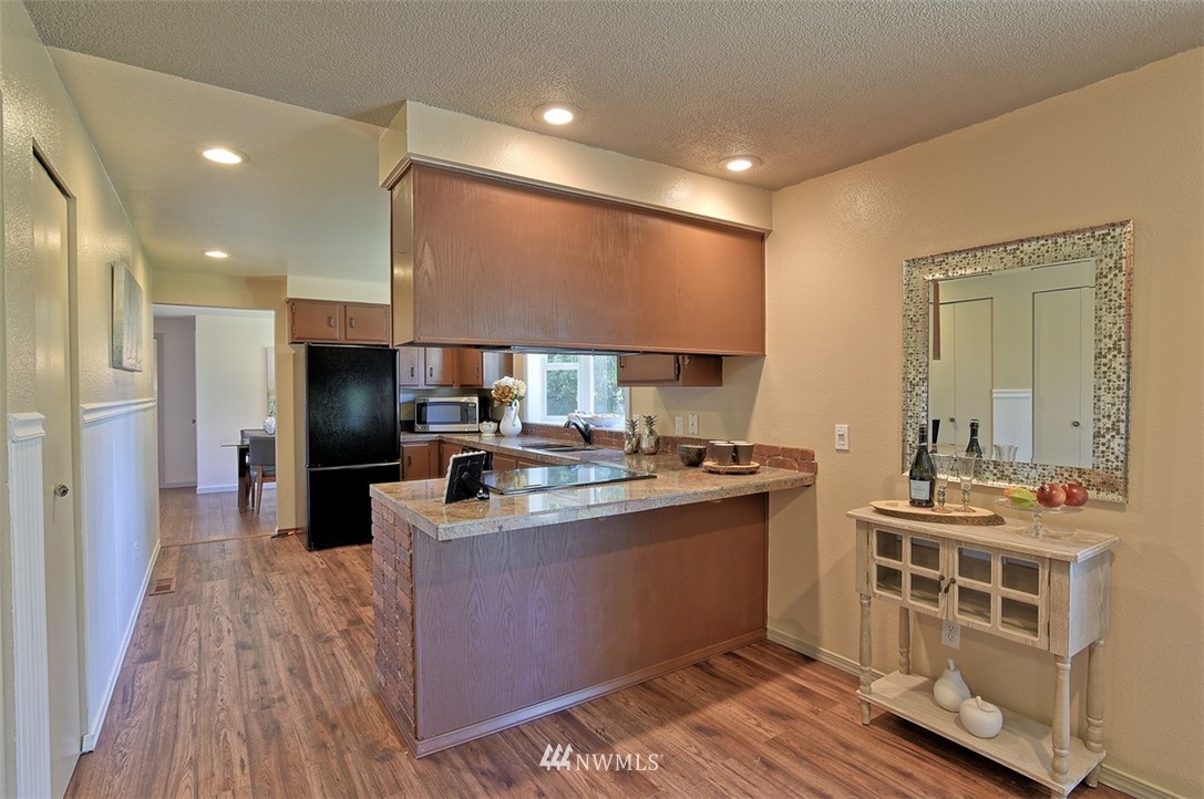 2417 171st Street Southeast Bothell, WA 98012 - Photo 8 of 18 a kitchen with stainless steel appliances a sink stove and refrigerator