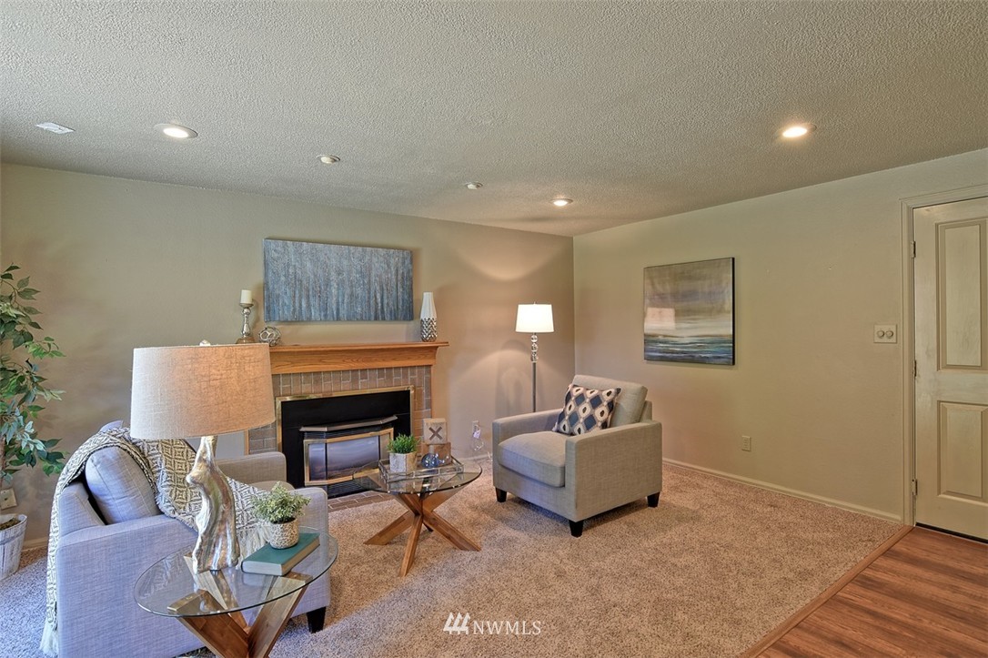 2417 171st Street Southeast Bothell, WA 98012 - Photo 9 of 18 a living room with furniture and a fireplace