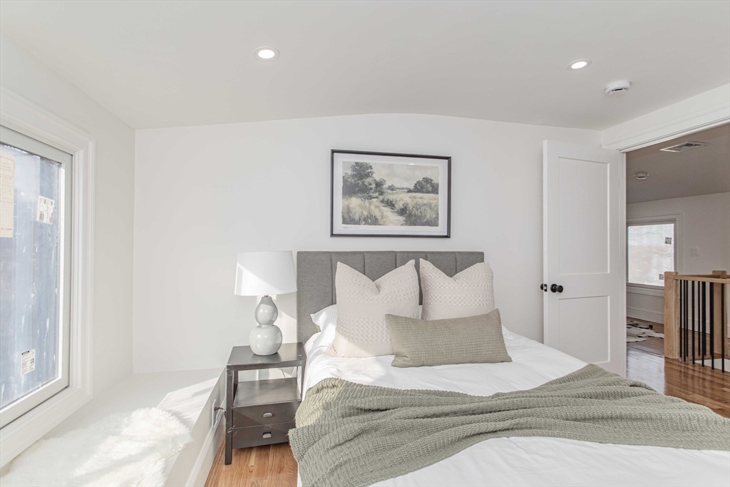 125 Mt Vernon Street, Unit 2 Newton, MA 02465 - Photo 34 of 36 a bed room with a bed and a painting